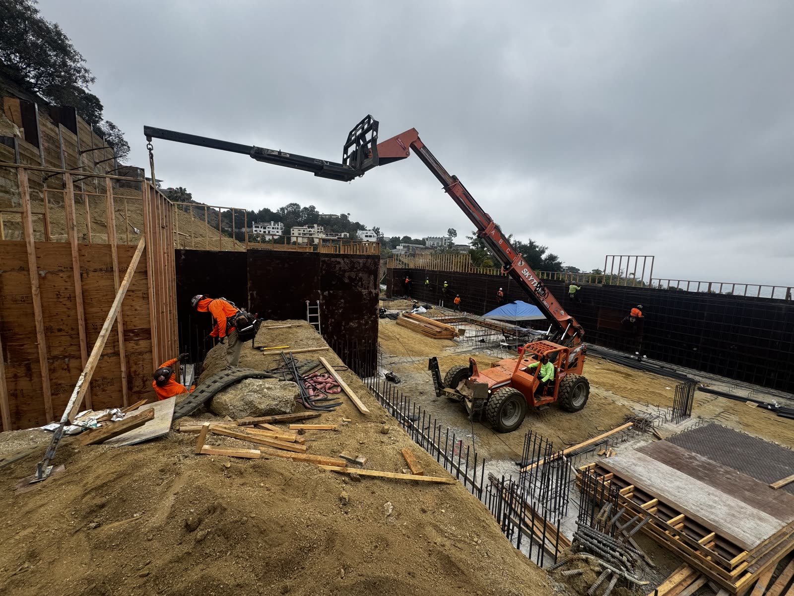 Crew framing and forming retaining walls on a hillside Los Angeles jobsite