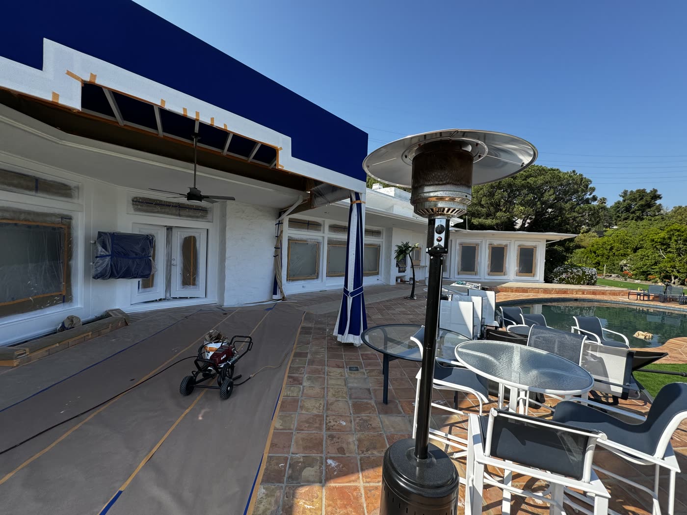 Tiled pool deck masonry surrounding a hillside home exterior